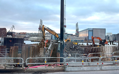 A construction site with a crane and a pole  AI-generated content may be incorrect.