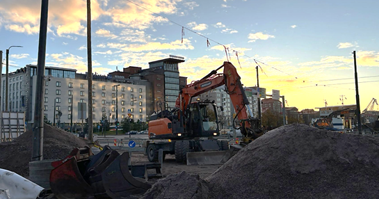 A construction vehicle in a city  AI-generated content may be incorrect.